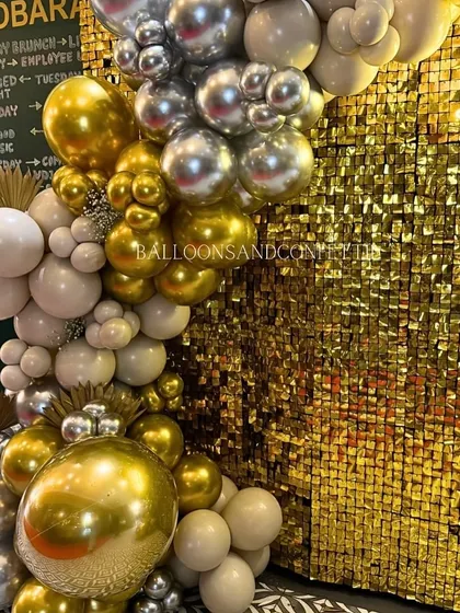 A close-up of the organic balloon arch, showing the mix of matte neutral, chrome gold, and chrome silver balloons. This color palette is sophisticated and trendy.