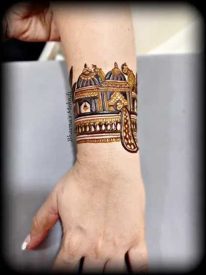 A beautifully shaded cuff design with peacock details, showing the depth and dimension we can create with henna.