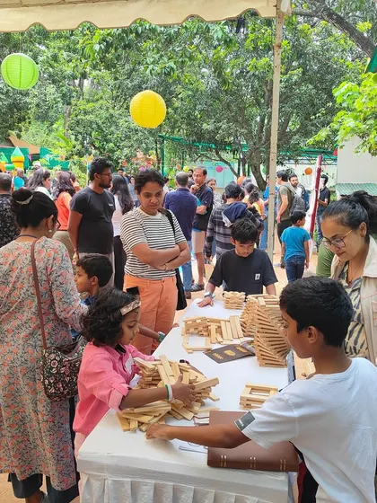 A wide view of our busy stall at an outdoor event. We love creating a welcoming space where families can stop, play, and discover the joy of building something together.
