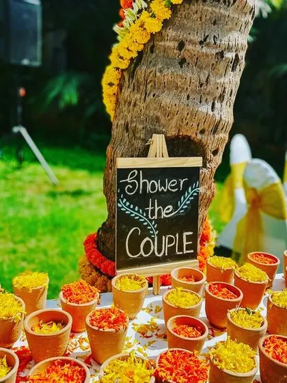 A creative way to involve guests: small terracotta pots filled with flower petals for them to shower the couple.