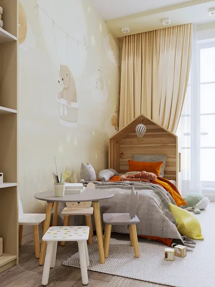 A close-up of the play and sleep area, featuring a low bed and a child-sized table and chairs for comfort and accessibility.