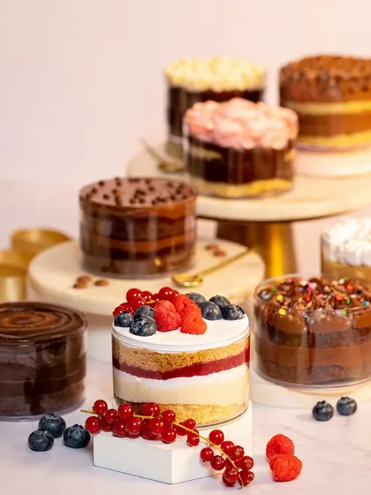 My full range of cake tubs for Rakhi. This spread shows the variety of flavors I offer, from chocolate and confetti to fresh fruit, ensuring there's something for everyone.