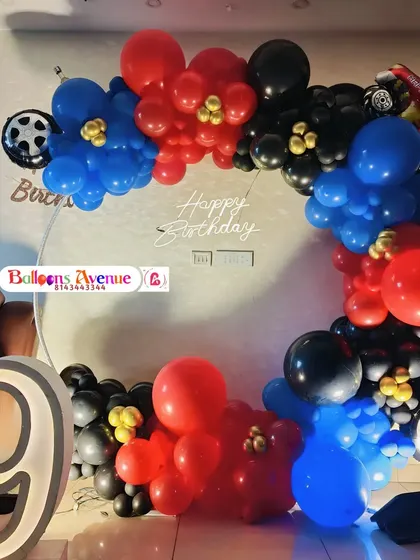 The full view of the car-themed ring decoration, featuring a large marquee number '9' and a 'Happy Birthday' neon sign.