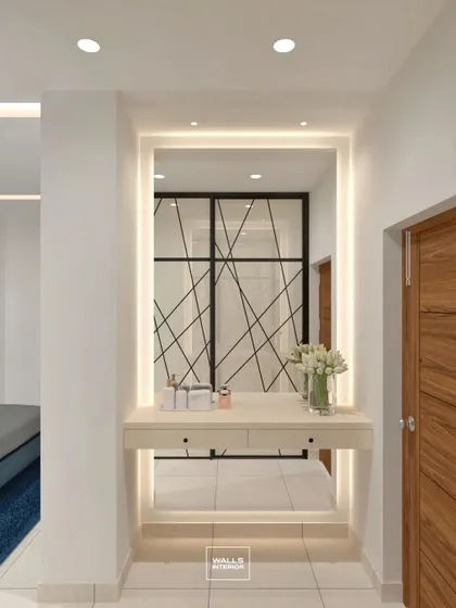 A floating dressing console or entryway table with a large, backlit mirror. This elegant piece creates a bright and welcoming spot in a hallway or bedroom.