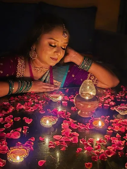 A moment of peace during the festival of lights. The makeup is designed to look beautiful even in the soft, ambient light of the diyas.