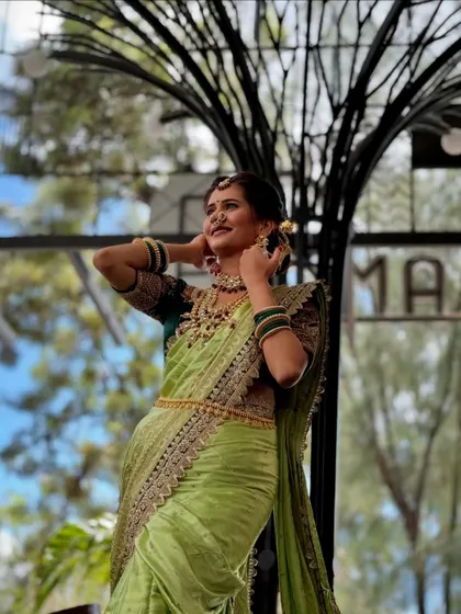 A powerful pose in the light green Nauvari. The drape is designed to create a strong and confident silhouette, perfect for a modern bride.