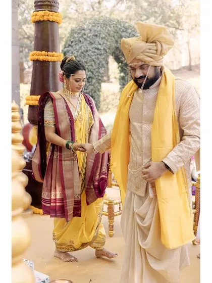 The couple during their Maharashtrian wedding ceremony. This shot captures a moment of ritual, showing the traditional attire and the solemnity of the proceedings.