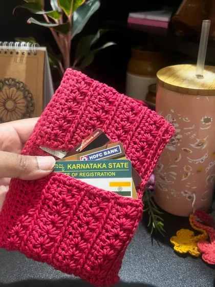 This is my no-coin wallet, or cardholder, in a beautiful bright pink. It's designed to be slim and practical, holding your cards on one side and cash on the other.