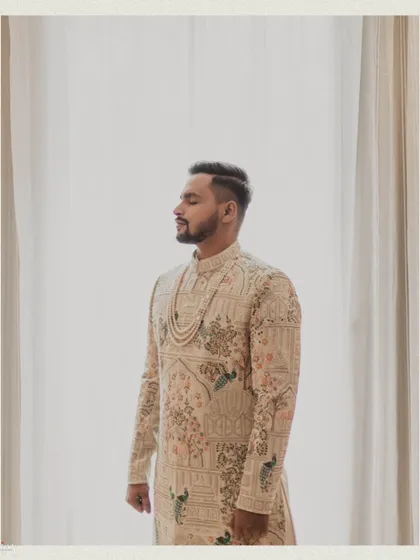A serene portrait of the groom with his eyes closed, captured in soft light.
