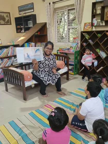 The storyteller shows a picture of a dolphin, sparking a discussion about marine life and conservation.