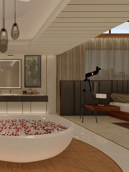 An open-concept primary suite where the bedroom flows into a luxurious bathroom. A freestanding bathtub is positioned for relaxation, while a skylight allows for stargazing from the comfort of the room.