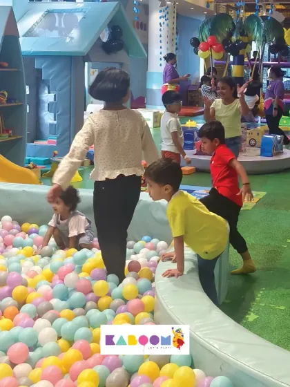 A wide shot of our play area, showing multiple families enjoying the space together. It's a community hub for fun.