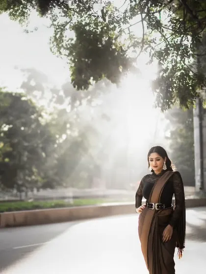 A full-length portrait of the bride on an empty road, with the morning sun creating a hazy, magical backlight. This is a perfect example of using golden hour for cinematic street photography.