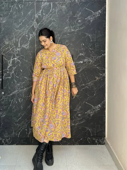 A simple yet effective Indo-western look. I've paired a floral yellow cotton dress with chunky black combat boots, giving a soft, traditional print a bit of modern edge.