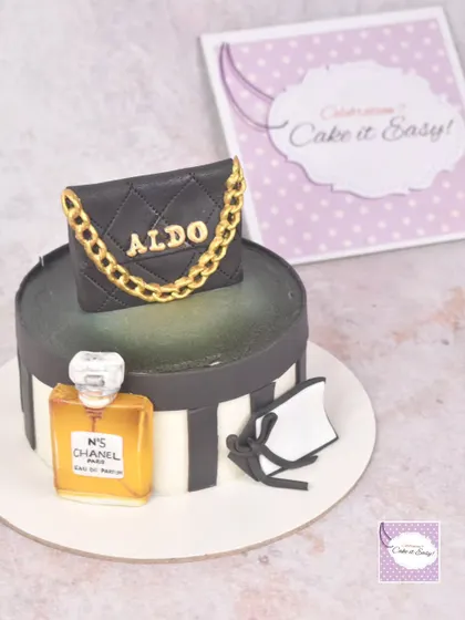 A fashion-themed cake featuring a miniature Aldo handbag and a bottle of Chanel No. 5 perfume. I especially loved hand-painting the perfume bottle to give it a transparent, glass-like effect.