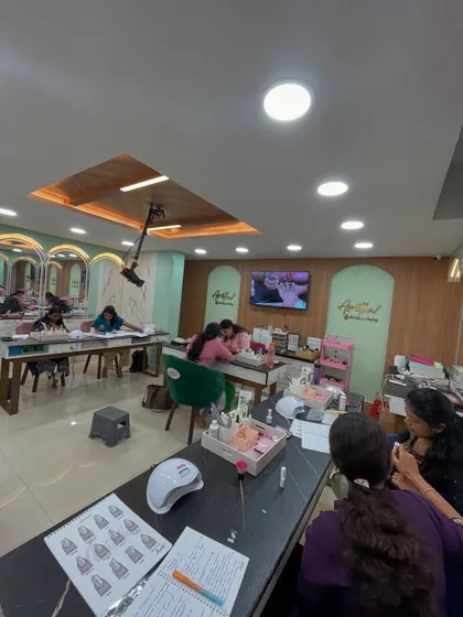 Our nail technician course in session, with a live demonstration projected on the screen for everyone to see clearly.