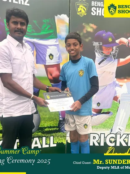 Mr. Sunder Raj felicitating one of our young footballers with his summer camp completion certificate.
