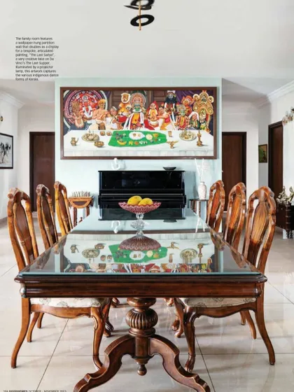 The reflection of the artwork on the glass dining table adds another layer of beauty to the space. The room is a perfect example of how we integrate bespoke art into our interiors.