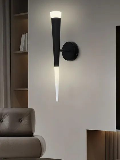 The torch-style wall sconce shown in a living room setting, adding a touch of modern elegance.
