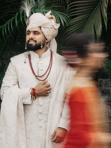 An artistic shot using slow shutter speed to capture the groom in focus while the bride moves past in a blur of color.