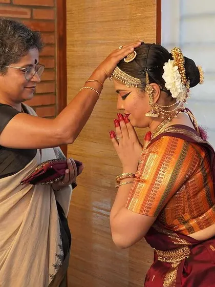 A touching moment backstage as a dancer receives blessings before her performance of "Rasa Yatra." We cherish these personal moments that are part of the artistic journey.