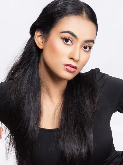 A beauty headshot of a model in a black bodysuit, with clean makeup and a direct gaze.