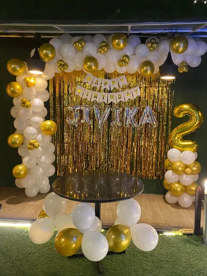 A full view of the white and gold second birthday setup.