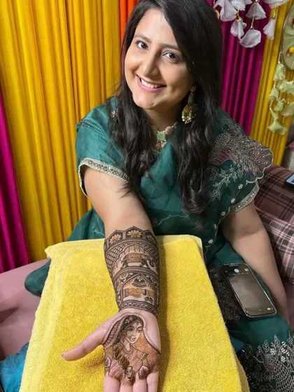 A smiling bride proudly displaying her custom portrait mehandi. Her happiness is my ultimate goal.