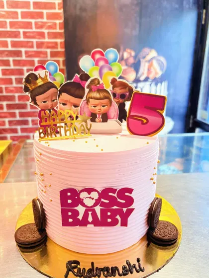 A pink Boss Baby cake for a girl's 5th birthday, featuring the female characters from the series.