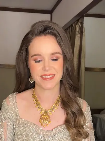 Another angle of Sarah's soft glam makeup. The peachy tones on her cheeks and lips give her a warm and healthy glow.
