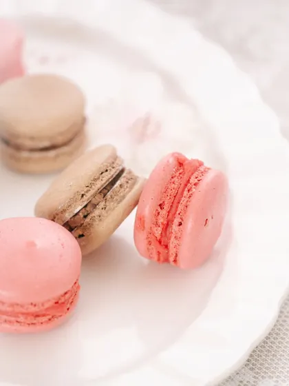 A clean, minimalist shot of macarons on a white plate, emphasizing their perfect shape and color.