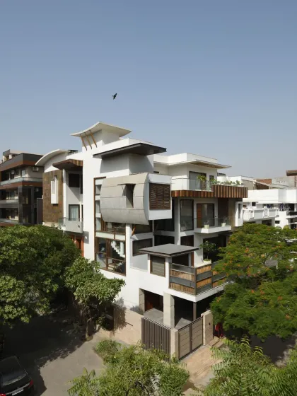 The Ashraya Residence, seen from an aerial perspective, reveals its complex composition of interlocking blocks and terraced gardens. This design is a modern interpretation of traditional Indian terraced farming, creating a home that is both sculptural and deeply connected to its site.