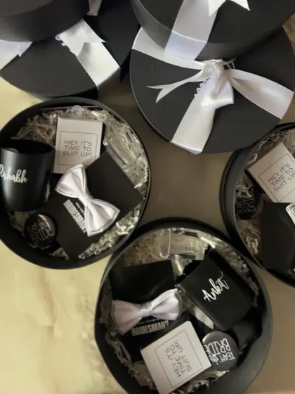 A collection of my round groomsmen proposal boxes, each tied with a satin ribbon and ready to delight your wedding party.