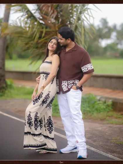 A stylish full-length portrait of Deepak and Aishwarya. Their coordinated outfits and confident poses on a country road create a modern and fashionable couple shot.
