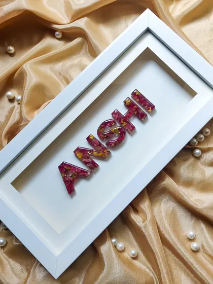 A wide shot of the custom name shadow frame, showing its clean lines and modern aesthetic. It's a beautiful way to add a personal touch to any room.