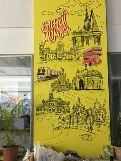 The "Aamchi Mumbai" pillar mural during its installation, showing the scale of the piece within the office space.