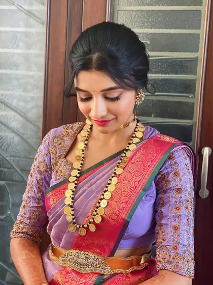 A closer look at the lavender saree and makeup. The soft updo and the coin necklace create a very elegant and traditional style.
