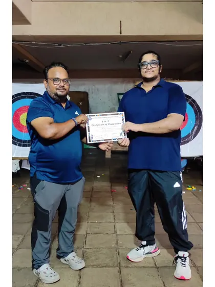 Presenting a certificate to another successful student. It's rewarding to see their dedication pay off.
