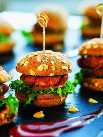 Our mini chicken sliders are a hit at casual corporate parties and team events. Served on oat-topped buns with fresh lettuce, they are a satisfying and delicious handheld option.