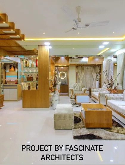 A spacious living room in a Vashi duplex, featuring light wood tones and classic white sofas. The design includes a custom bar and display unit, showcasing our ability to integrate entertainment and storage solutions seamlessly.