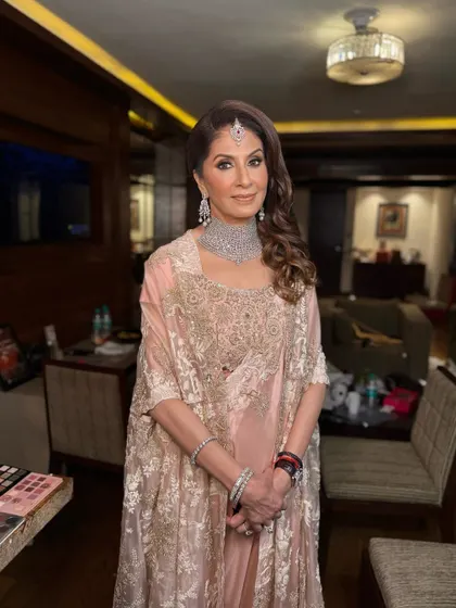 A full view of this ethereal and bronzed look. The makeup is flawless and glowing, perfectly complementing her Anamika Khanna outfit.
