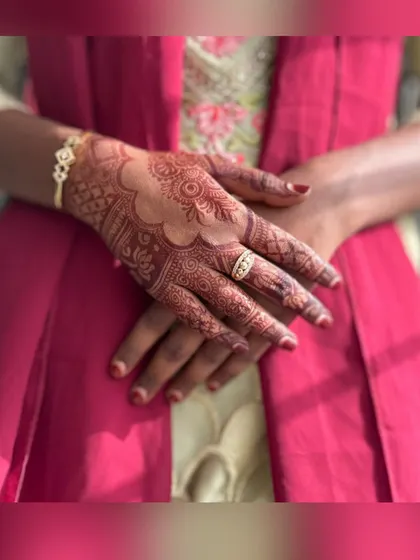 A close-up of a henna stain, showing a mix of traditional patterns with a scalloped border. This is a great example of a design for a wedding guest or party.