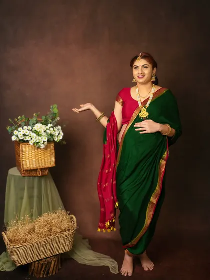A joyful and welcoming pose. The mom to be looks radiant in her traditional attire, surrounded by simple, rustic props that complement the look.