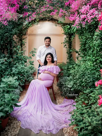 A duplicate of 88, this image captures the couple seated in a floral paradise, a perfect representation of a garden maternity shoot.