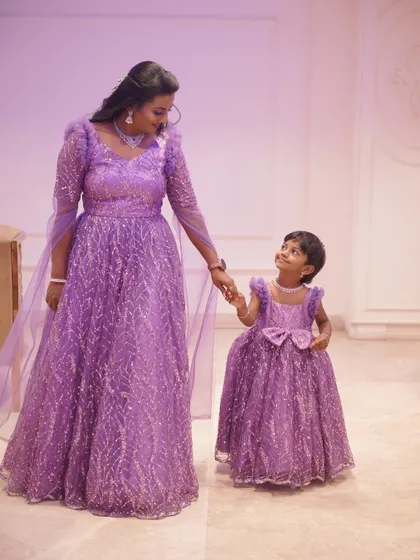 A magical mother-daughter moment. Tharuna and her little one in matching lavender gowns, sparkling with sequins.