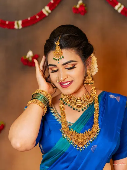 A close-up portrait focusing on the traditional jewelry and makeup from a styled shoot.