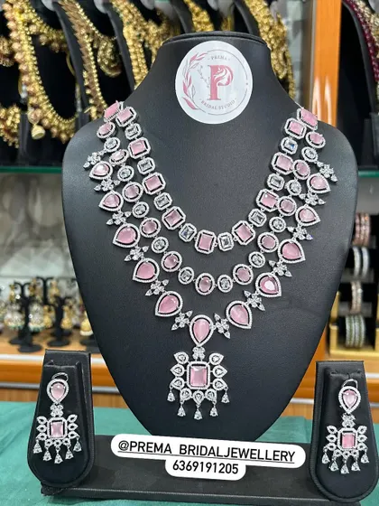 A modern layered necklace set with pink stones.