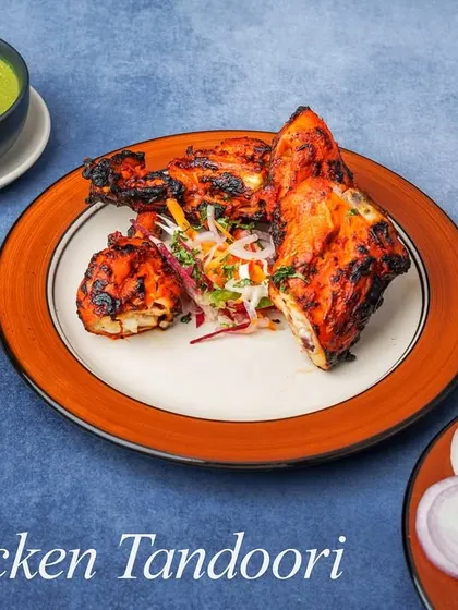 A classic full Chicken Tandoori, marinated in yogurt and a blend of traditional Indian spices, then roasted in the tandoor until the skin is crisp and the meat is succulent. Served with salad and mint chutney.