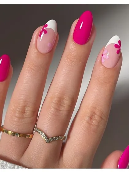 A bright and cheerful floral design. This set combines solid magenta nails with accent nails featuring a modern French tip and delicate pink flower art.