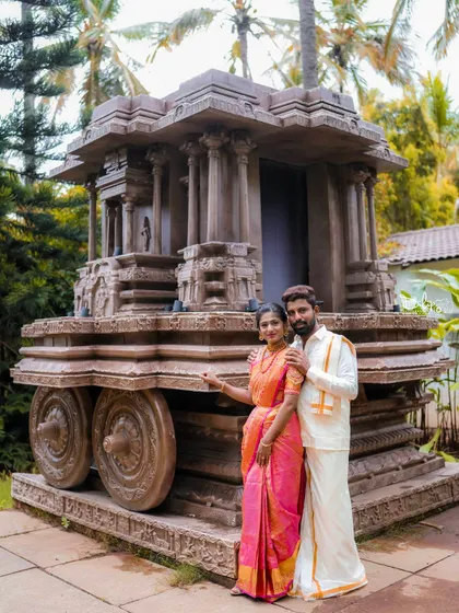 A classic portrait of a couple in traditional attire by our Hampi stone chariot replica.